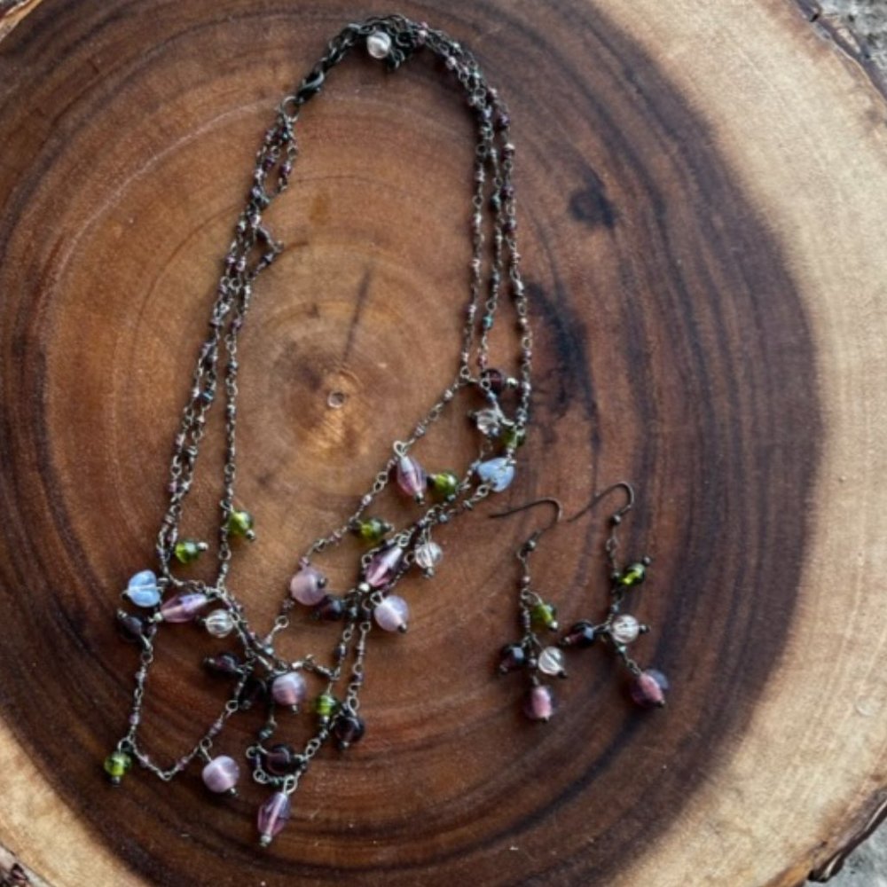 Beaded necklace and earrings with purple and green accents